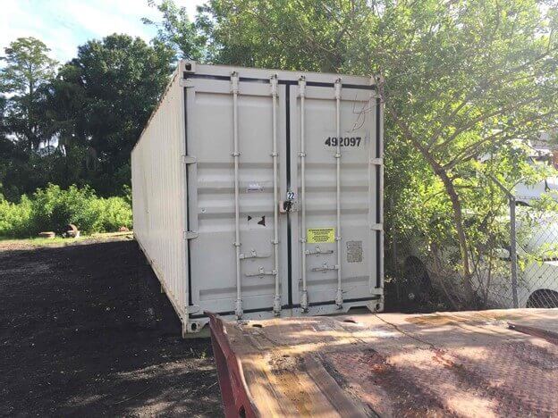 White Storage Container in yard unloaded. 