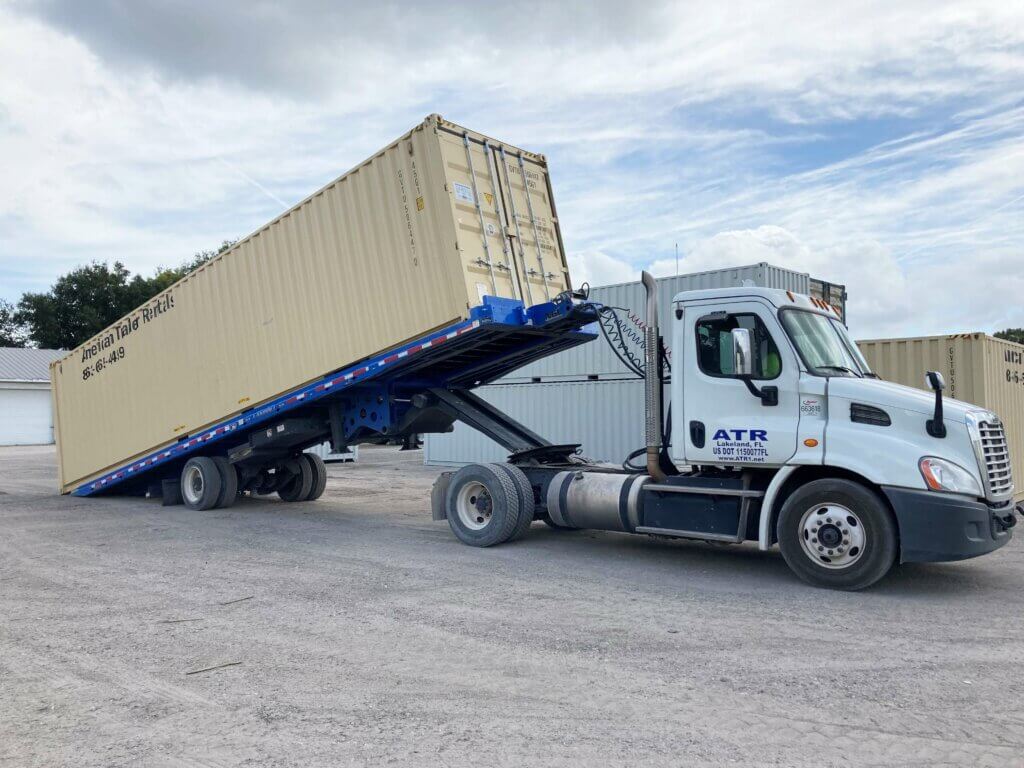 40' storage container being unloaded off of landoll