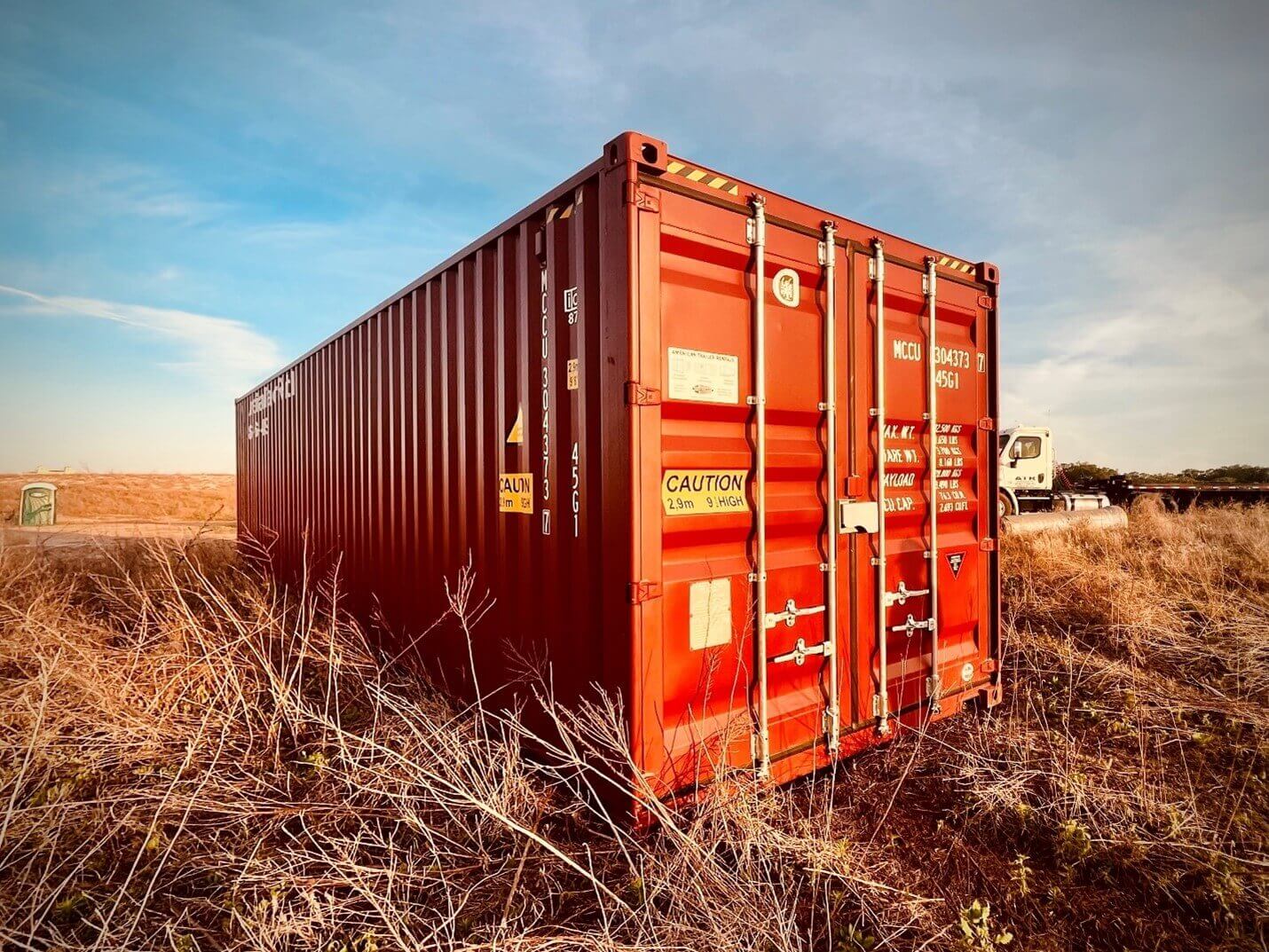 Red 40' Storage container in the sunrise