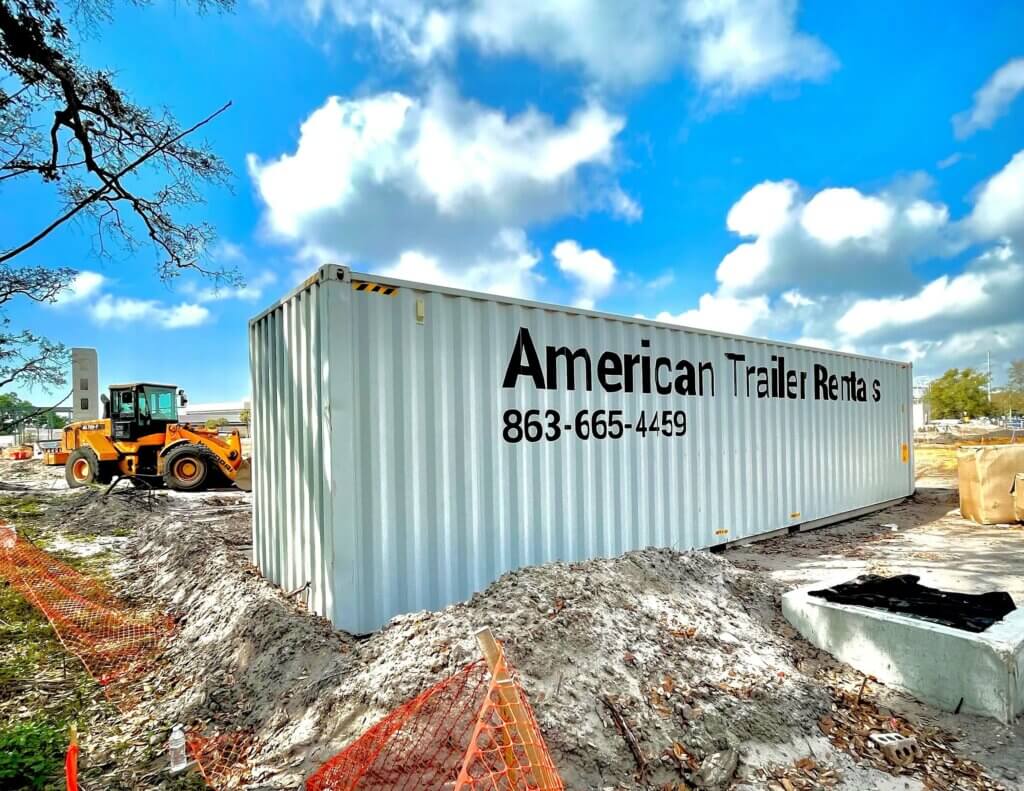 gray 40' storage container with blue sky and American Trailer Rentals on the front