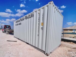 gray 20' Storage container delivered infront of blue sky