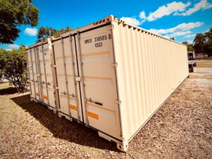 tan 40' High Cube containers on gravel with pretty blue sky