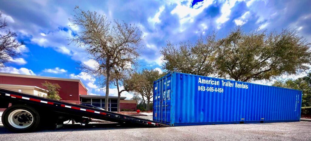 BLUE 40' STORAGE CONTAINER BEING UNLOADED