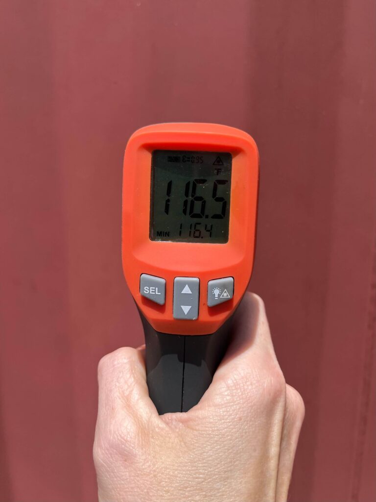 thermometer showing the exterior temp of a red storage container